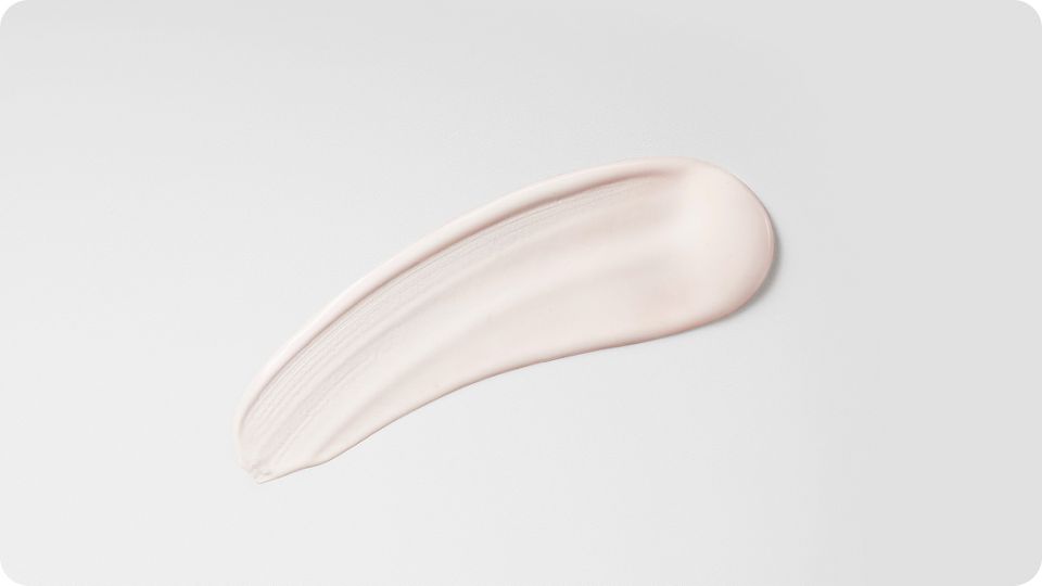 Et sveip med Post-style-serum på hvit bakgrunn med struktur.