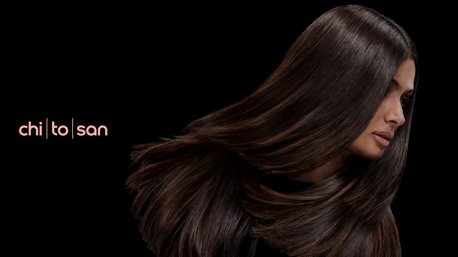 A brunette model with voluminous hair styled with Dyson Chitosan.