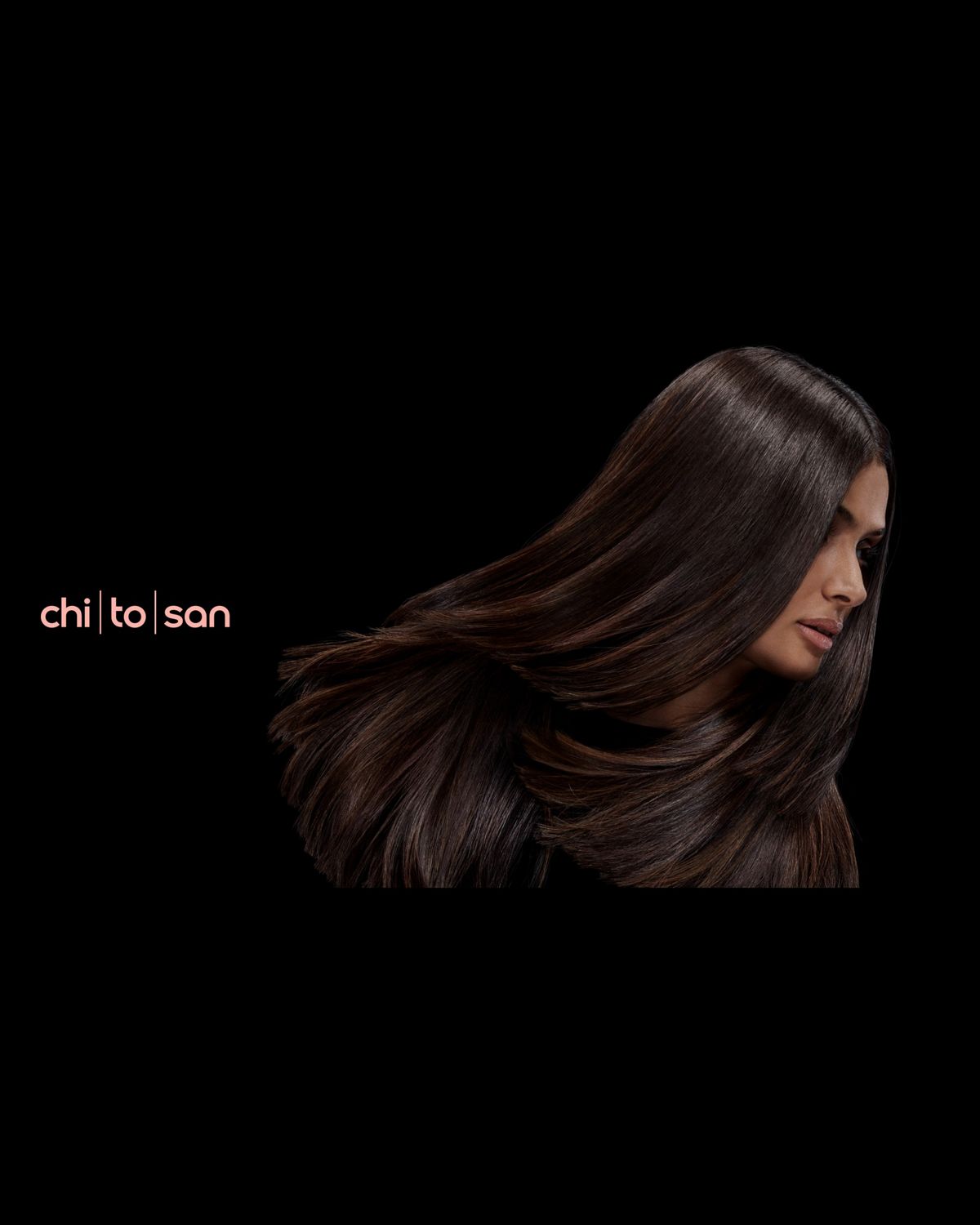A brunette model with voluminous hair styled with Dyson Chitosan.