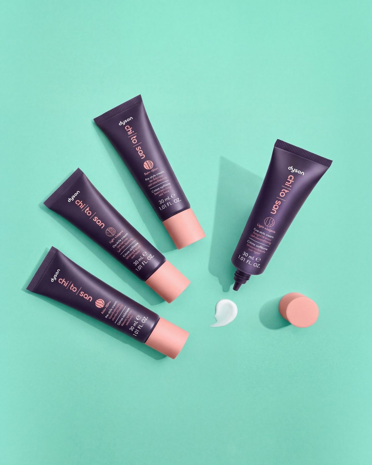 The Dyson Chitosan Pre-style cream range in 30ml sizes laid on a surface.