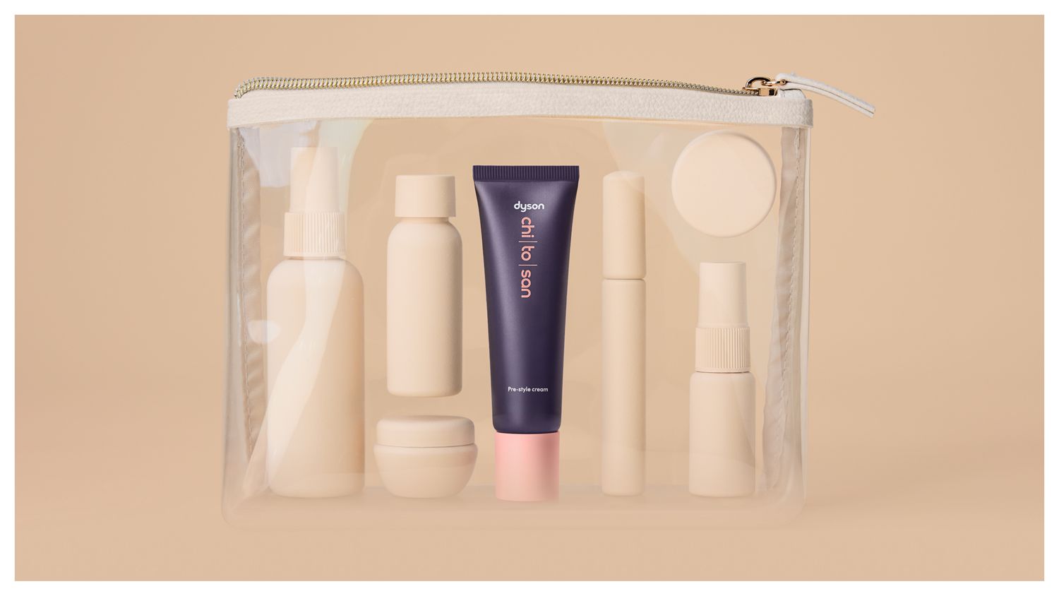 Dyson Chitosan Pre-style cream mini 30ml with other toiletries in a clear travel bag.