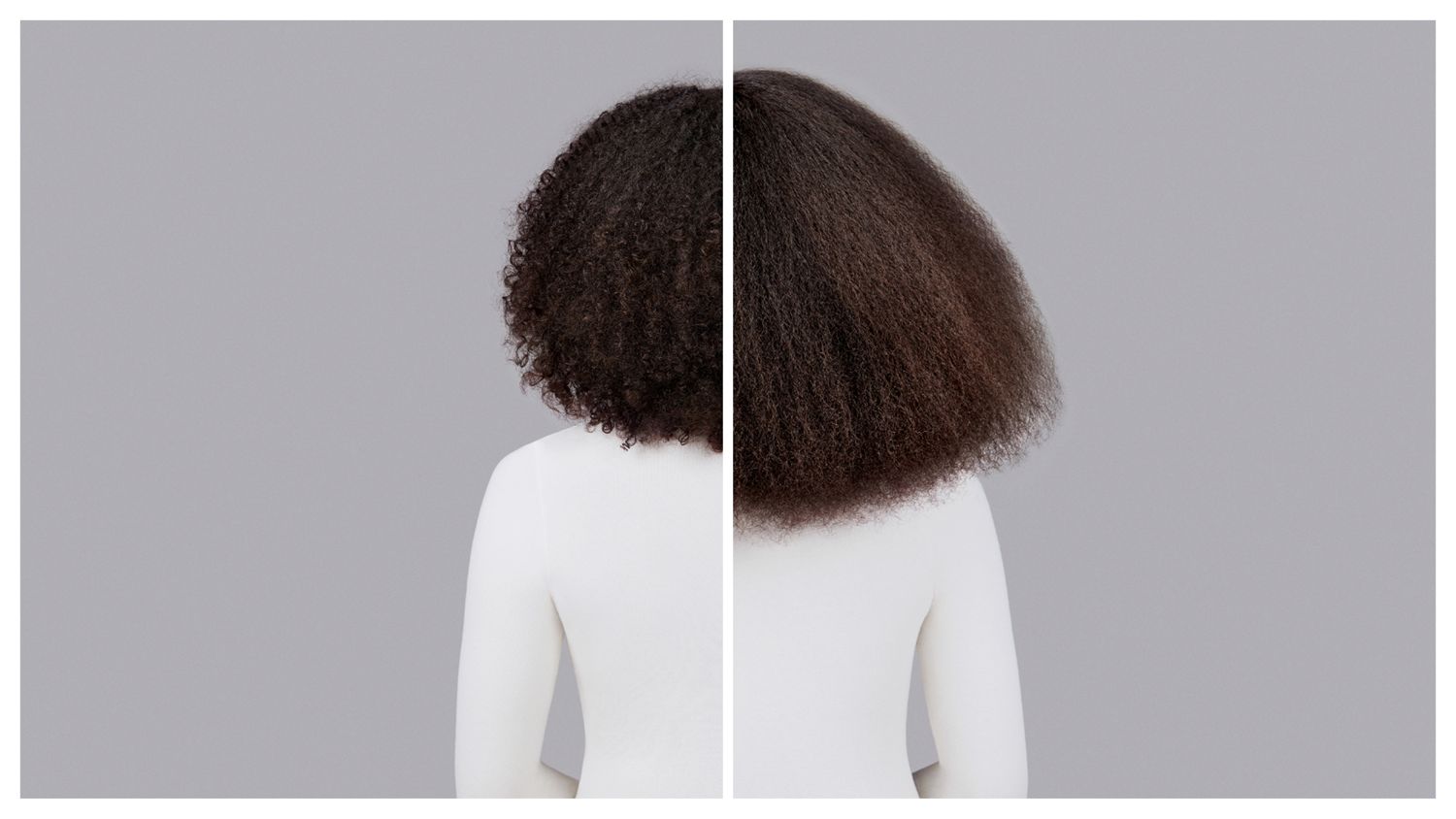 Naturally coily dark brown hair styled with Dyson Chitosan Pre-style cream and the Dyson Supersonic Nural. Seen from behind.