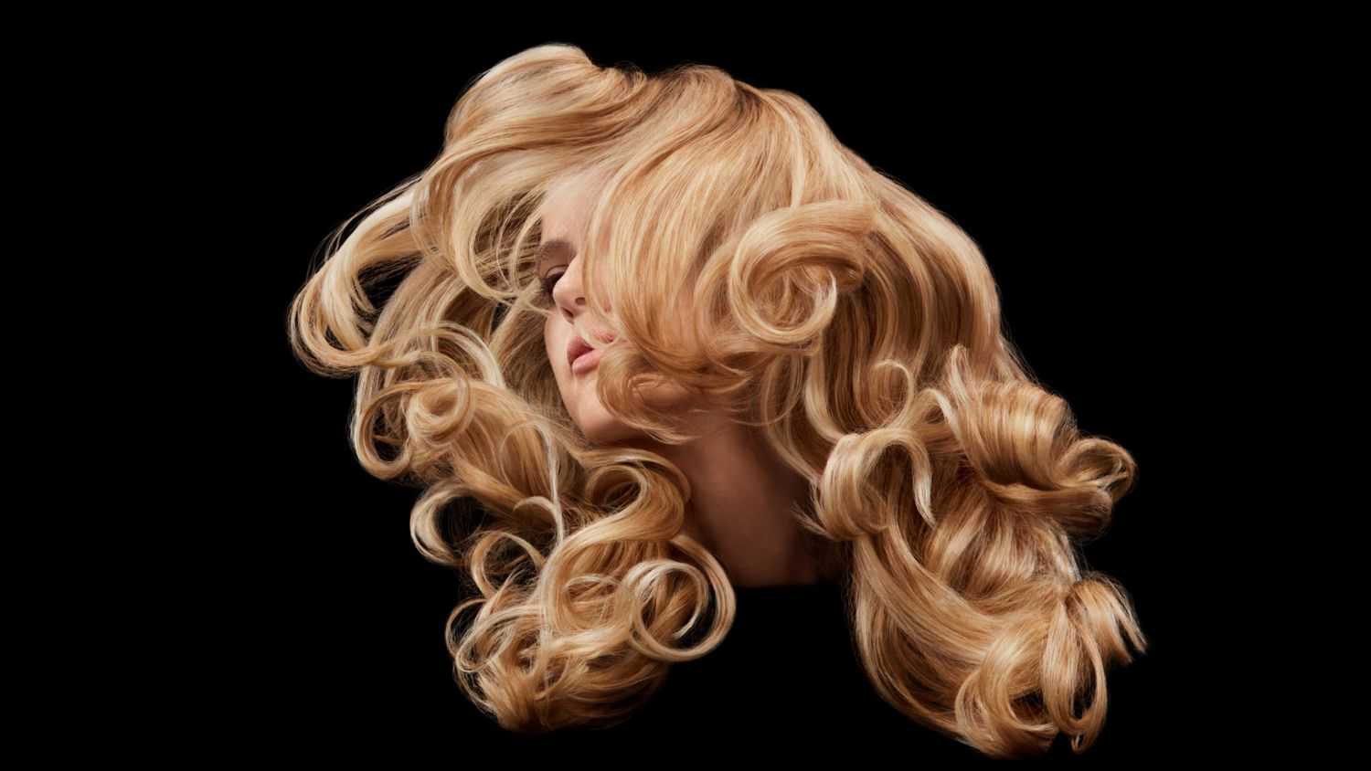 A model with blonde hair next to a list of Dyson Chitosan Pre-style cream’s key benefits: It holds, conditions and defines with up to 50% less frizz. Shielding from up to 80% relative humidity.