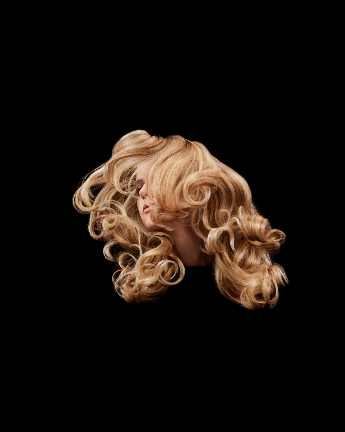 A model with blonde hair next to a list of Dyson Chitosan Pre-style cream’s key benefits: It holds, conditions and defines with up to 50% less frizz. Shielding from up to 80% relative humidity.