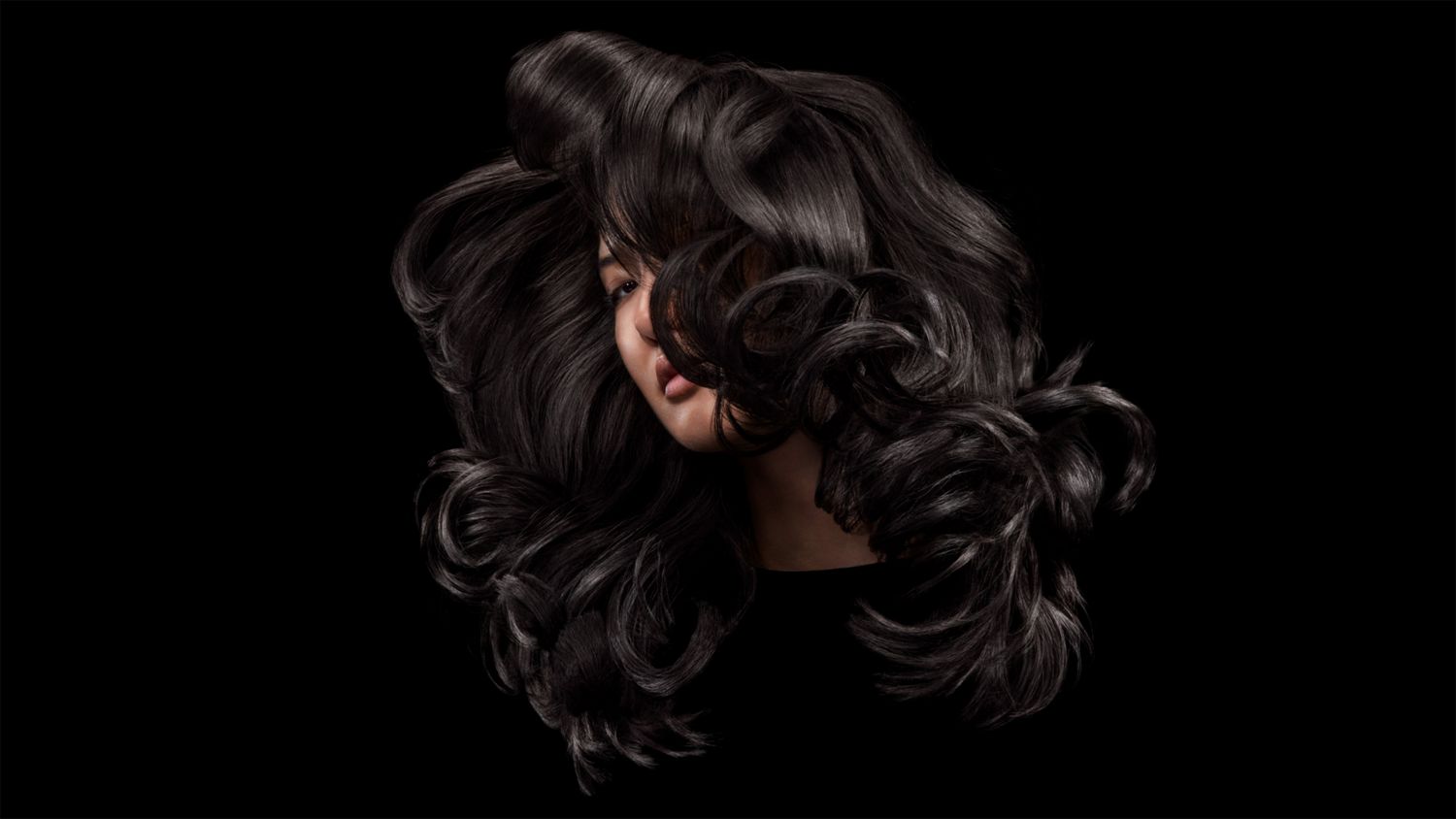 A blonde model after styling their hair with Dyson Chitosan Pre-style cream.