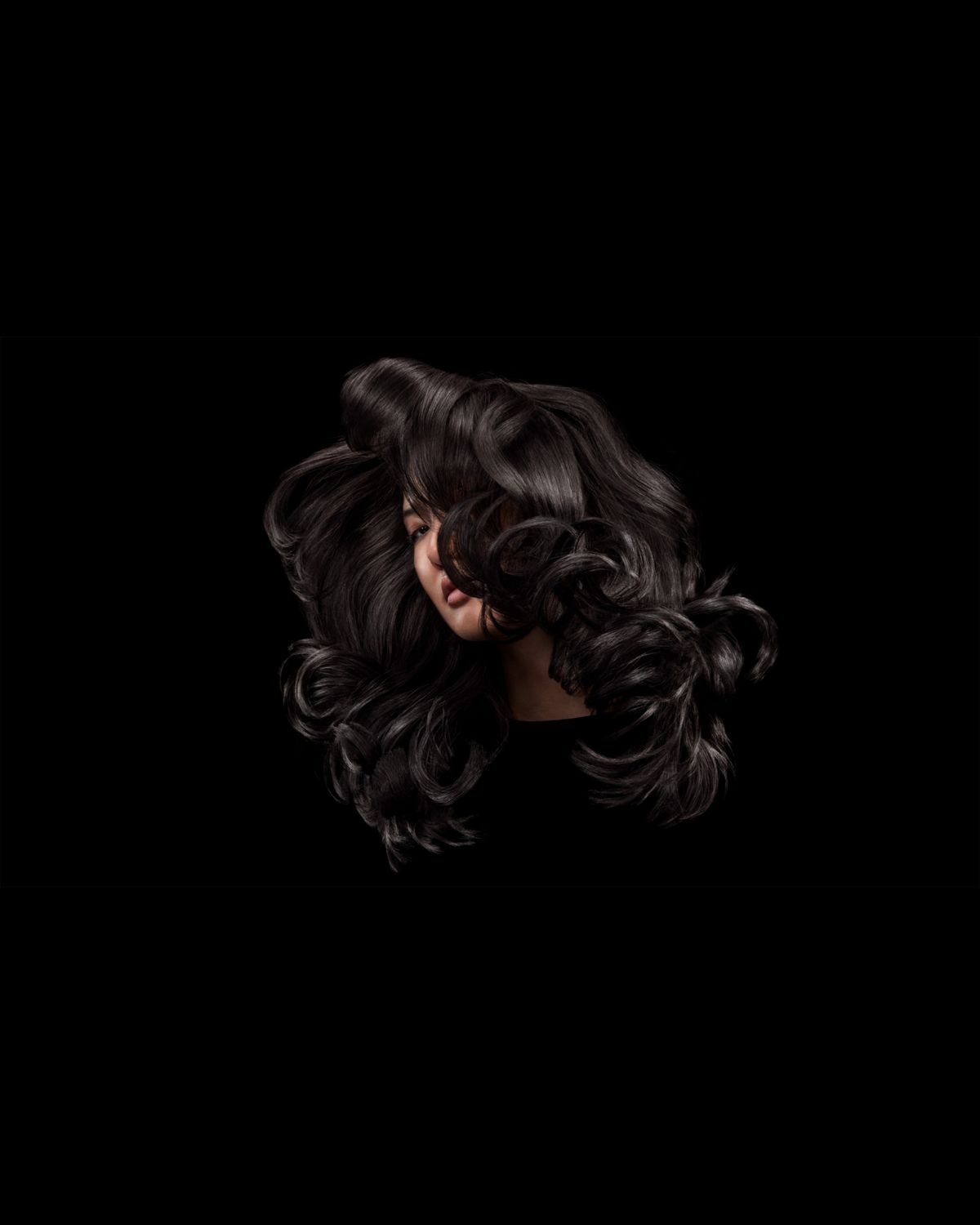 A blonde model after styling their hair with Dyson Chitosan Pre-style cream.
