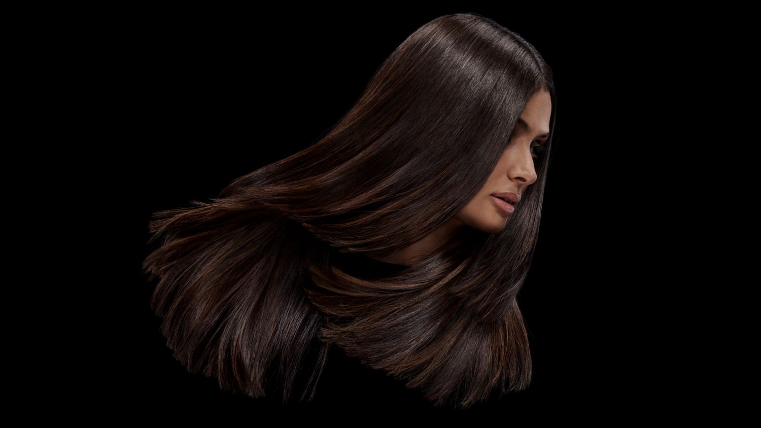 A model with black hair after styling their hair with Dyson Chitosan Pre-style cream.