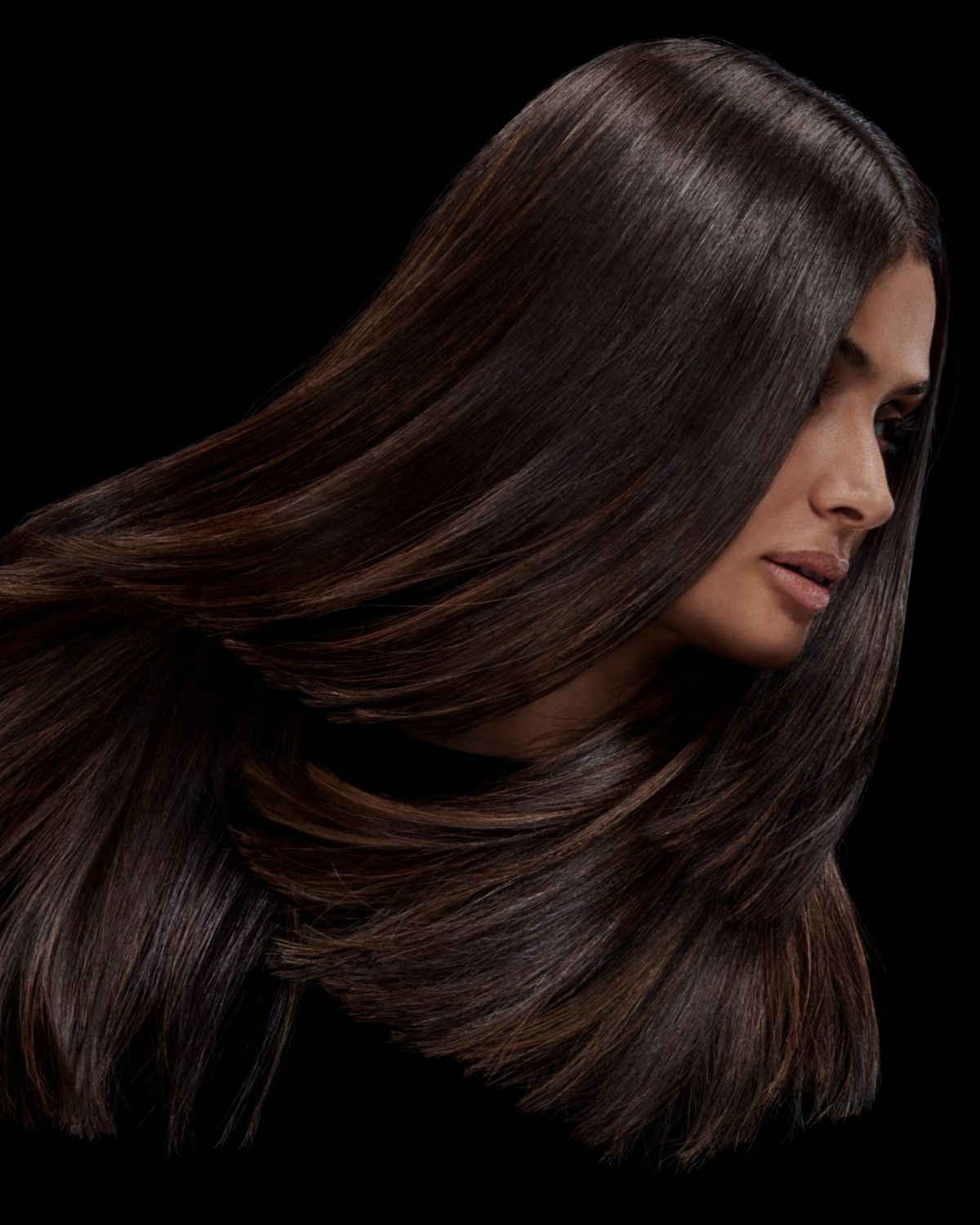 A model with black hair after styling their hair with Dyson Chitosan Pre-style cream.