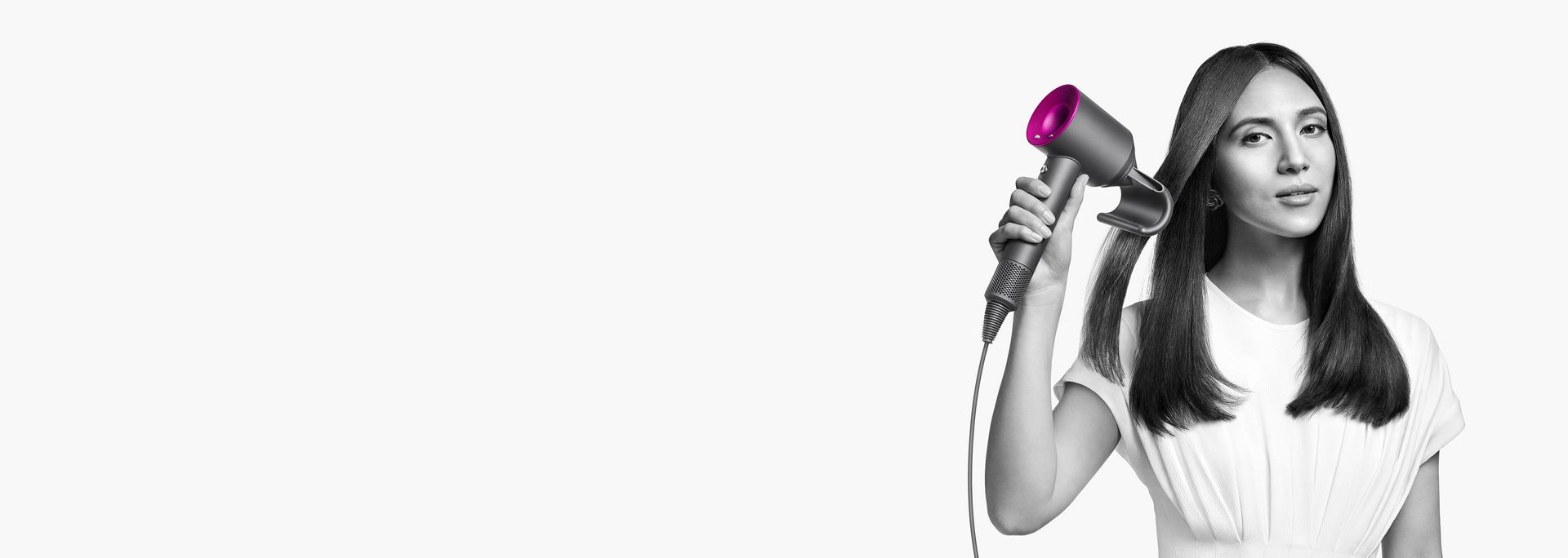Model using a Dyson Supersonic hair dryer.