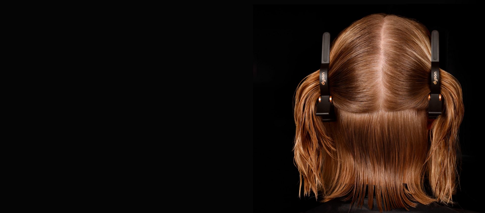 A model with two Sectioning hair clips parting her hair.