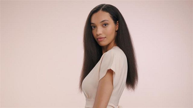 A model with long, black hair, worn in a stretched bubble puff ponytail.