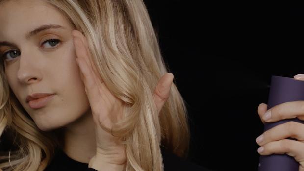 Dyson Chitosan Multi-use styling spray is used by a model to style her hair.