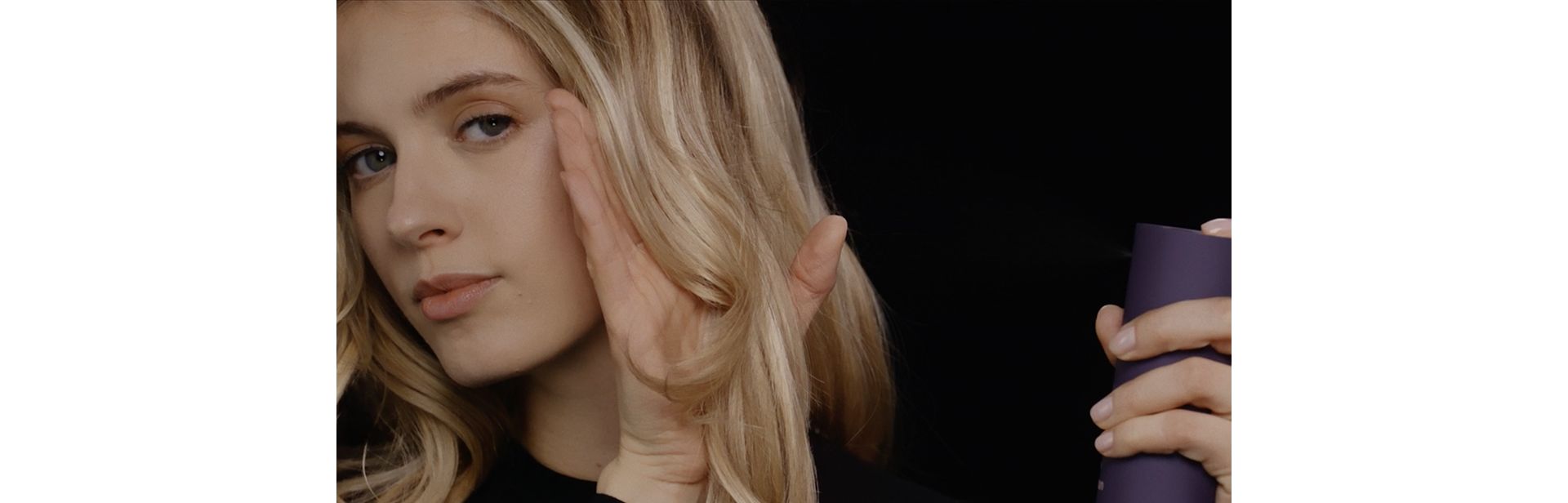 Dyson Chitosan Multi-use styling spray is used by a model to style her hair.