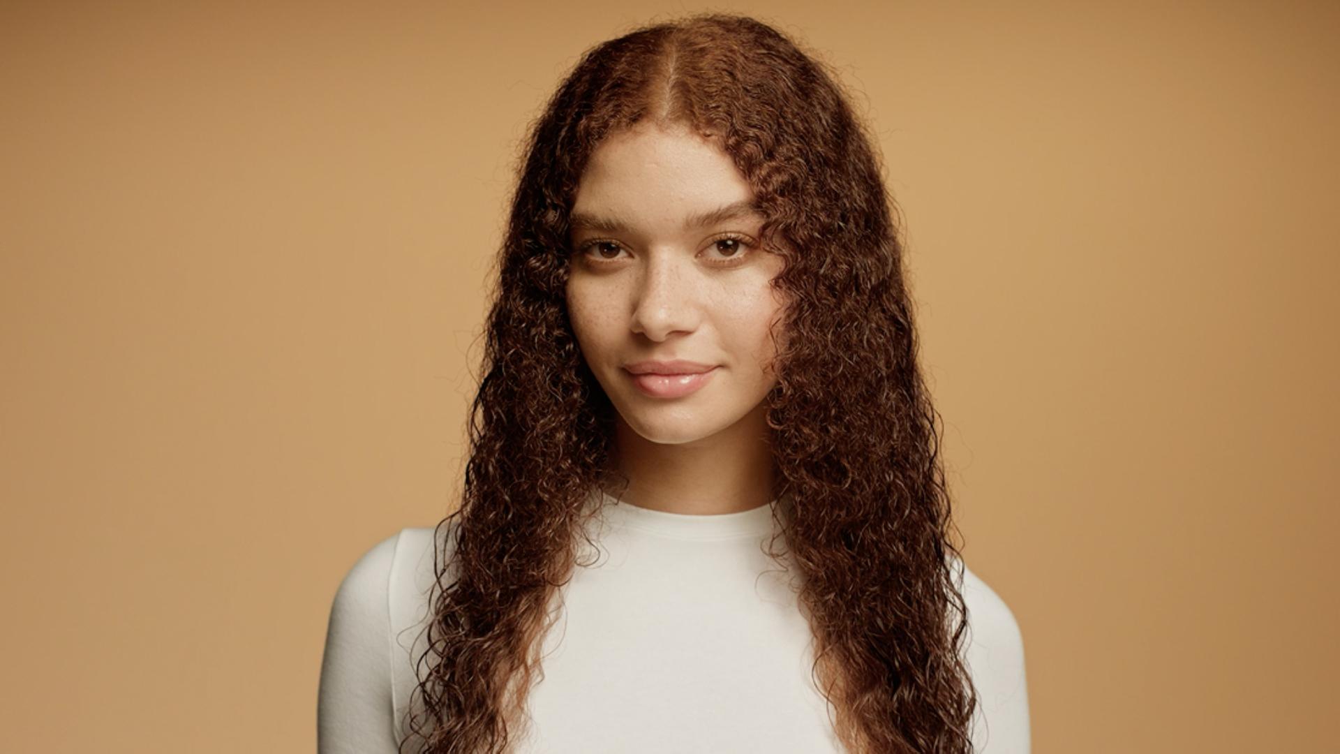 Model with damp, towel-dried hair.