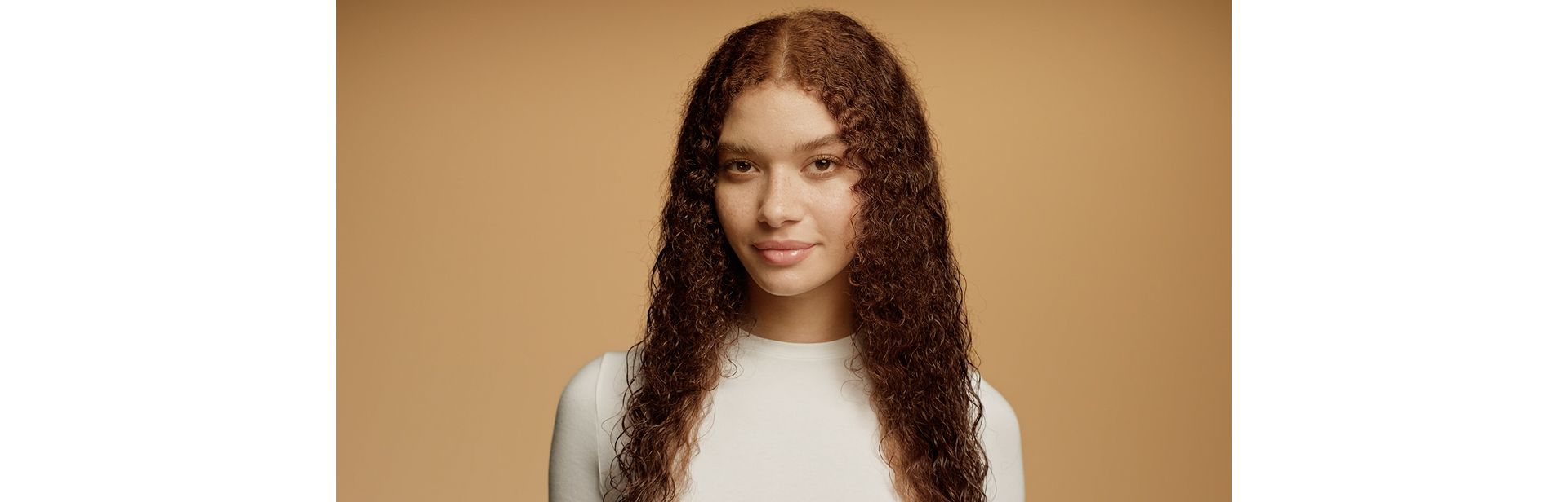 Model with damp, towel-dried hair.