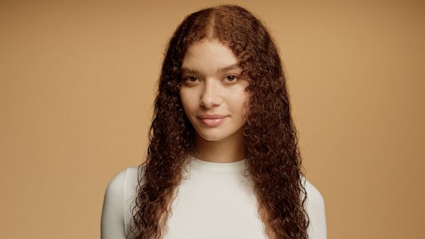Model with damp, towel-dried hair.