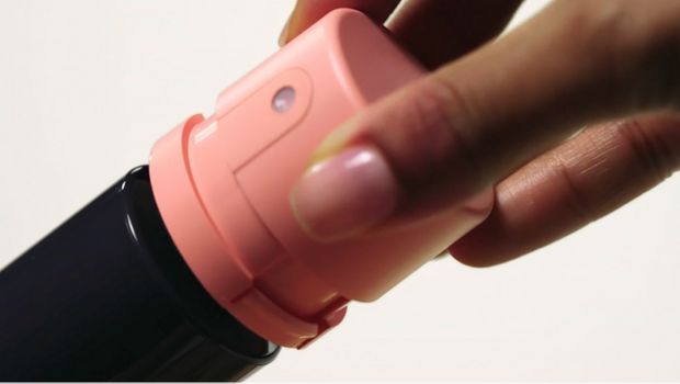 The pump of a Dyson Beauty bottle is removed from the bottle.