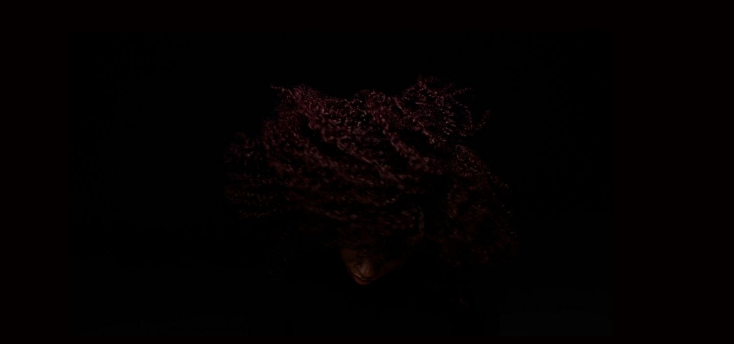 Model with curly hair after using the Dyson Chitosan Pre-style cream Curly to coily light conditioning