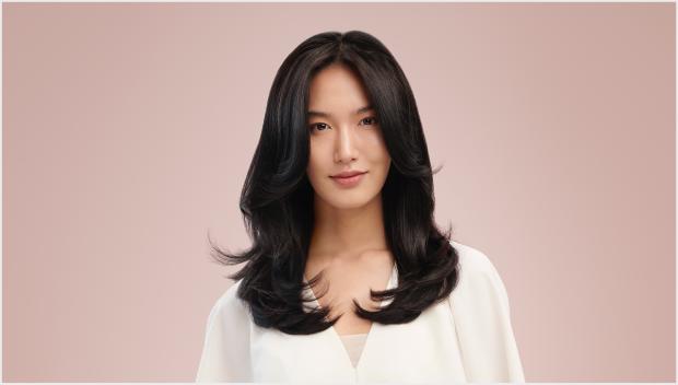 Model wearing a smooth c-curl style