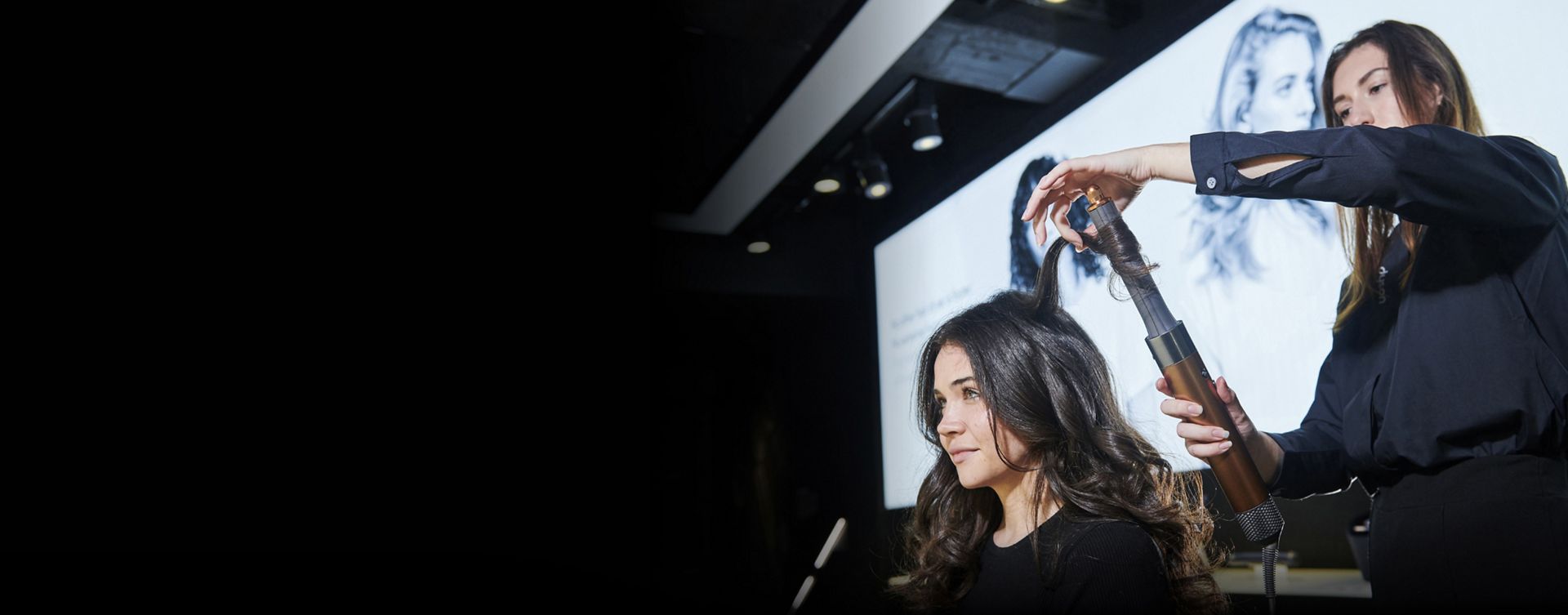 Woman having her hair styled by a Dyson Stylist