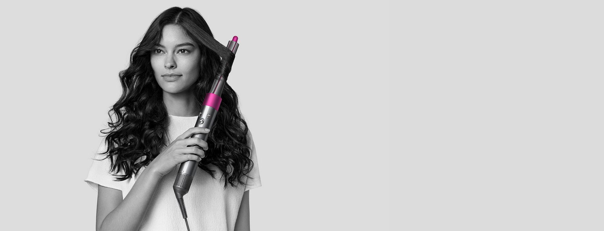 Woman styling hair with Dyson Airwrap styler.