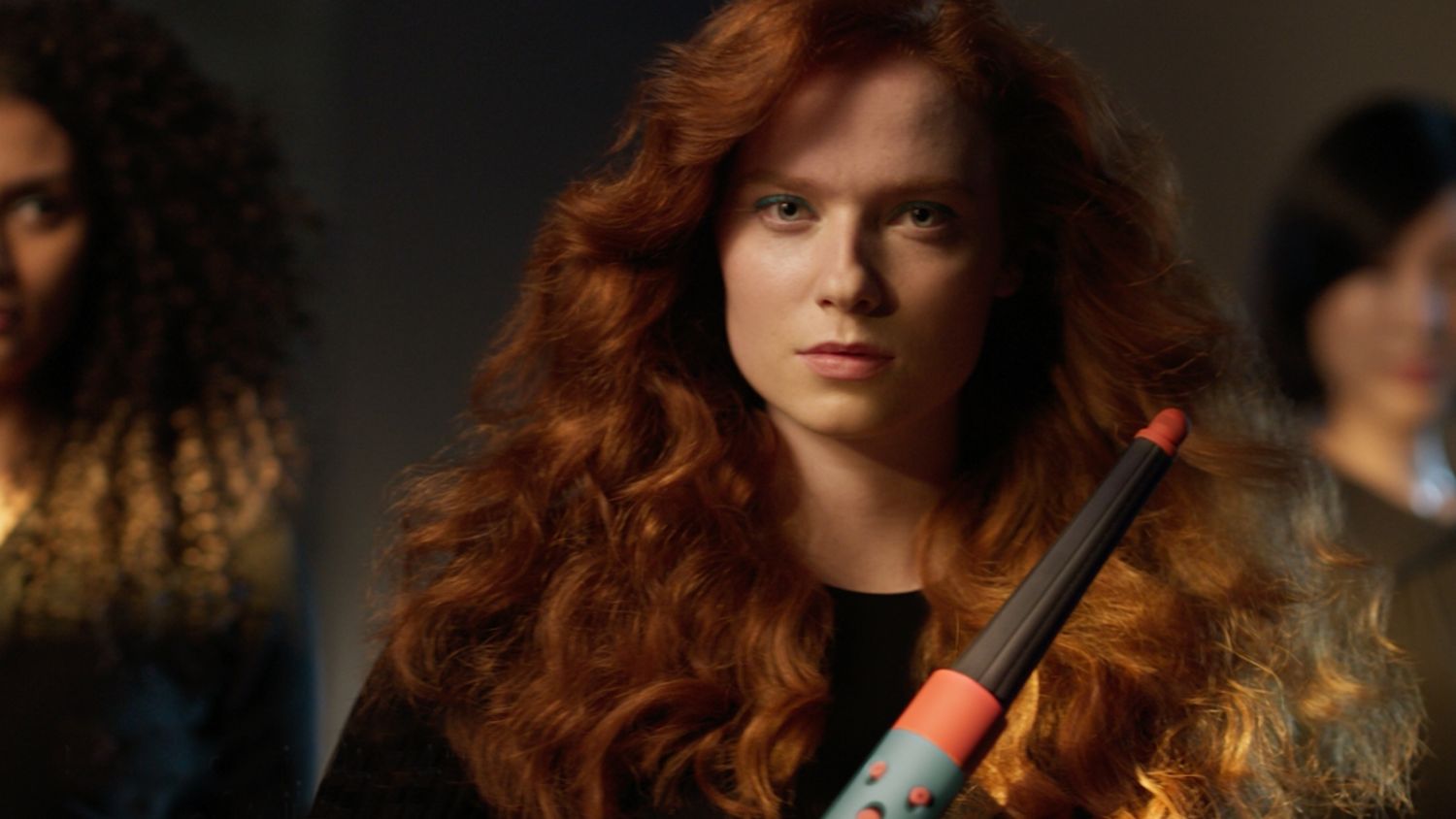 Model using Ceramic Patina Dyson Airwrap i.d multi-styler and dryer to add waves to their hair.