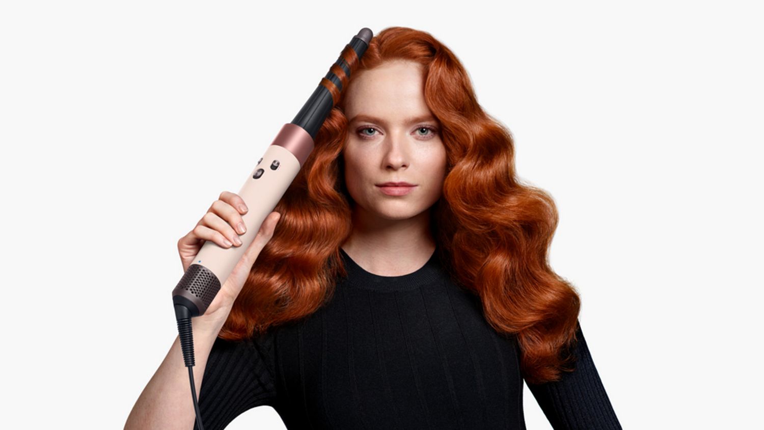 Front-on view of a woman curling her hair with the the Dyson Airwrap ID.