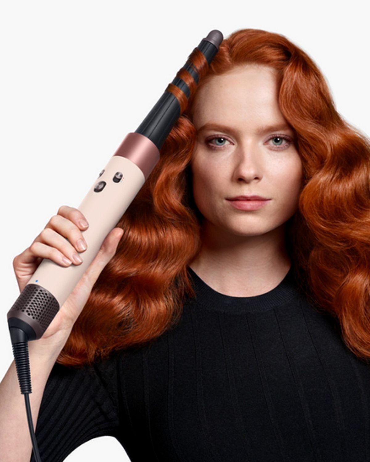 Front-on view of a woman curling her hair with the the Dyson Airwrap ID.