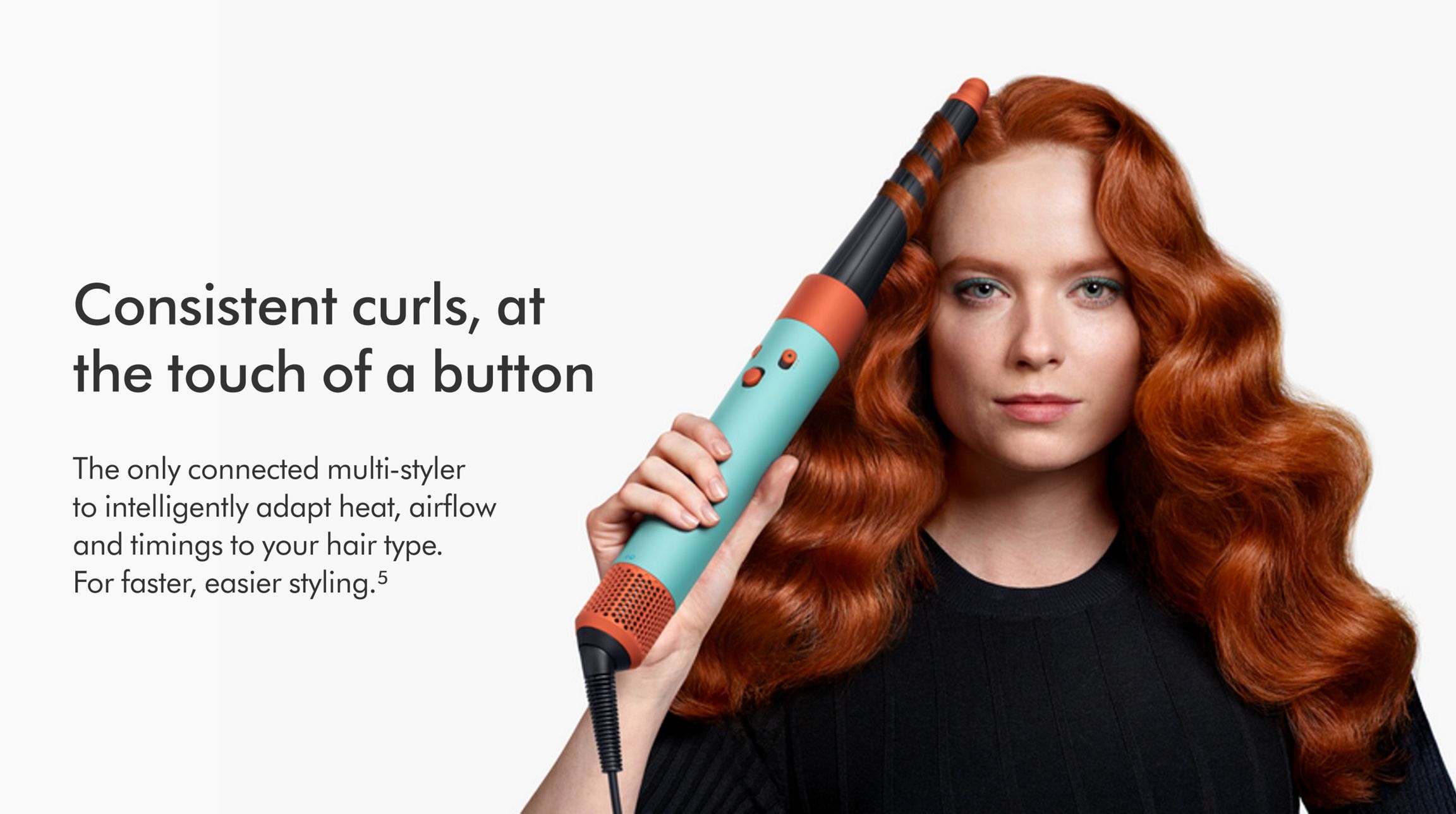Dyson HS08 Airwrap i.d. multi-styler and dryer Straight+Wavy (Ceramic Patina/Topaz) 11 Front-on view of a woman curling her hair with the the Dyson Airwrap ID.