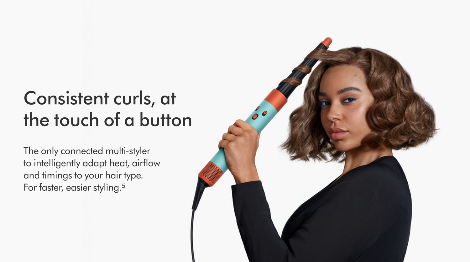 Woman curling hair with the Dyson Airwrap ID multi-styler.