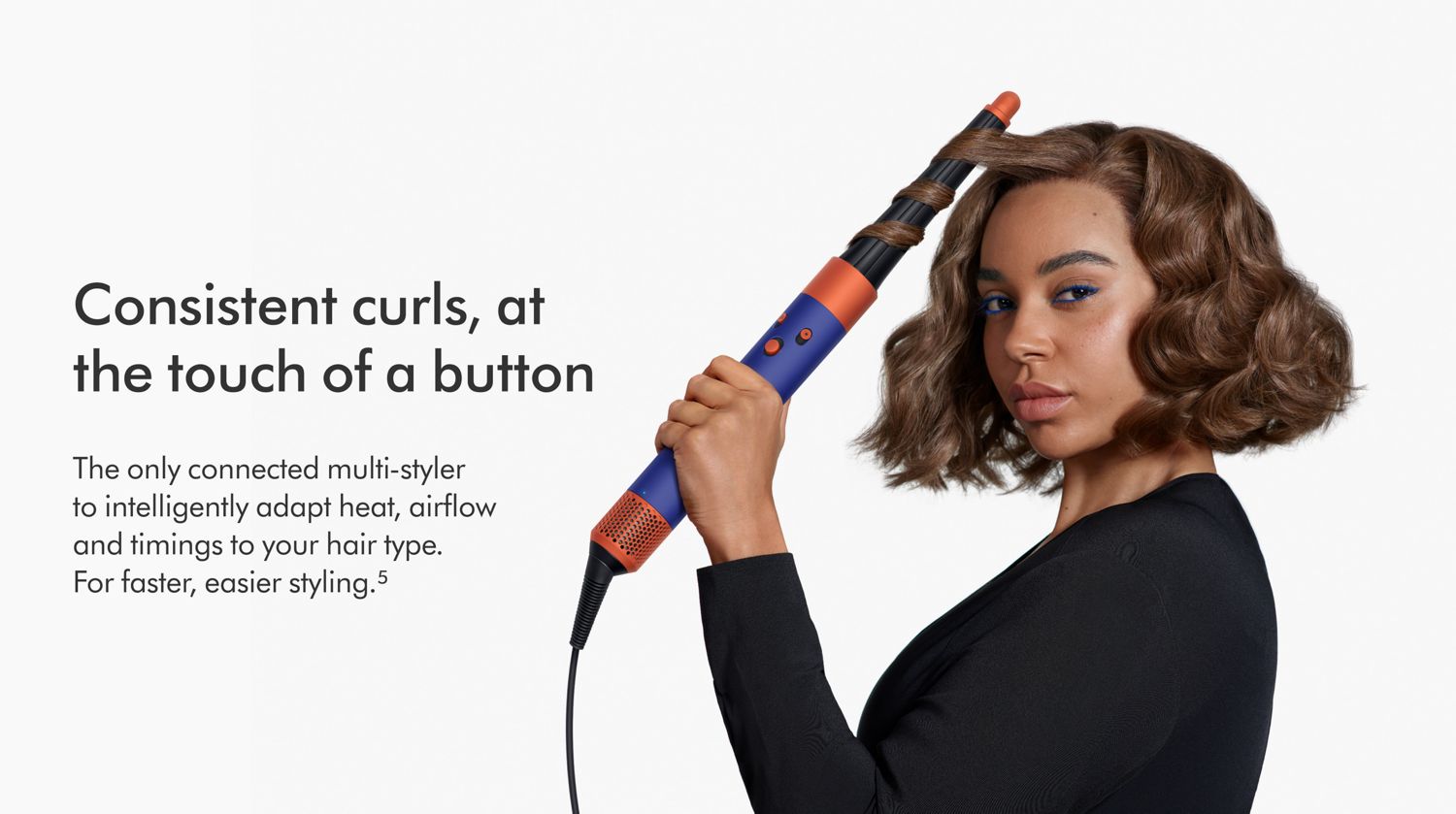 Woman curling hair with the Dyson Airwrap ID multi-styler. 