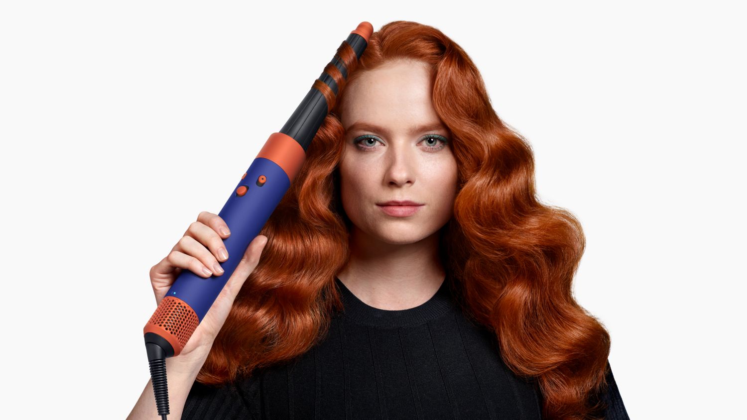 A model using the Vinca Blue Dyson Airwrap i.d multi-styler and dryer to add waves to their hair.