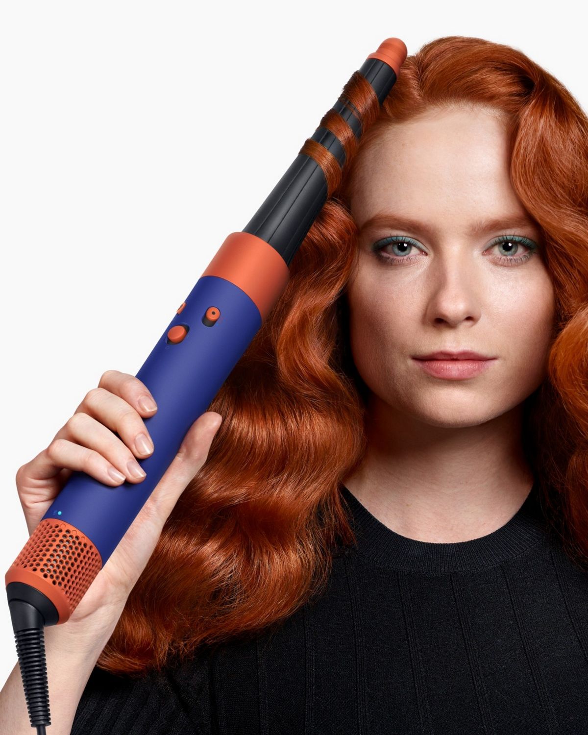 A model using the Vinca Blue Dyson Airwrap i.d multi-styler and dryer to add waves to their hair.