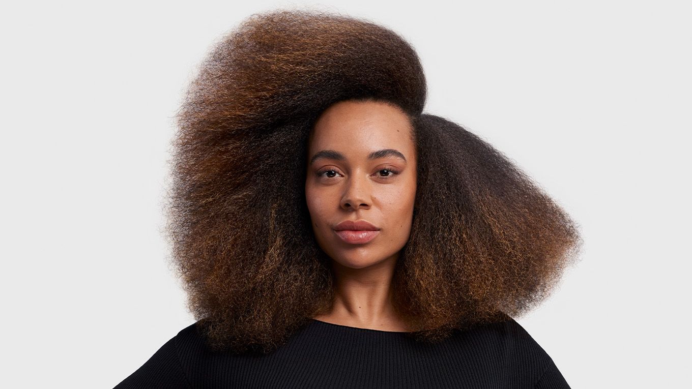 Model with stretched blow out styled hair. Model with stretched blow out styled hair.