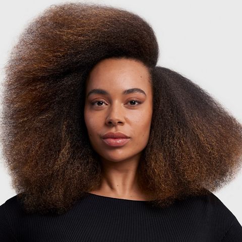 Model with stretched blow out styled hair.