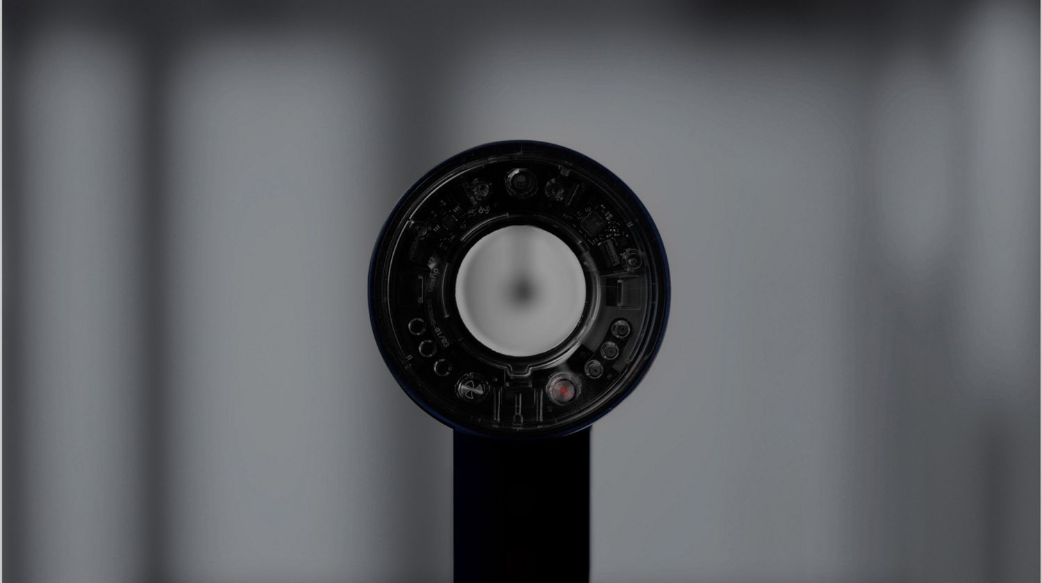 Model drying hair with the Dyson Supersonic r hair dryer.