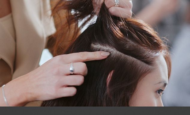 A stylist styling hair