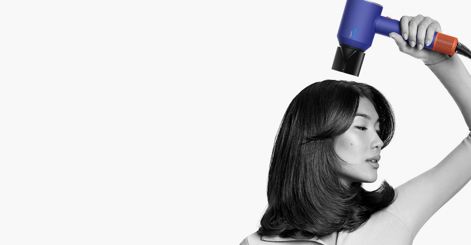 Une femme en train d’utiliser le concentrateur pour brushing