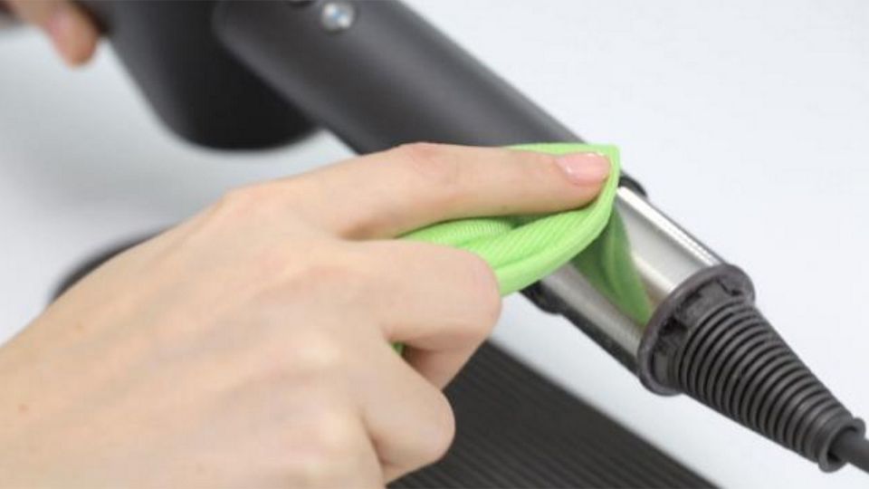 Wiping the filter with a cloth.