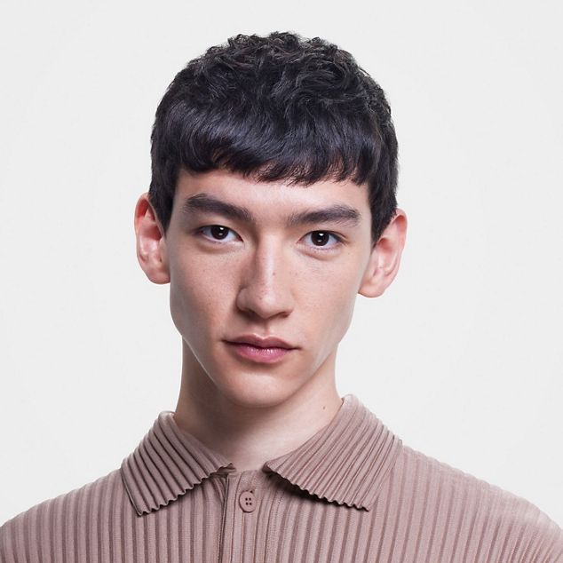 Male model with short, straight hair.