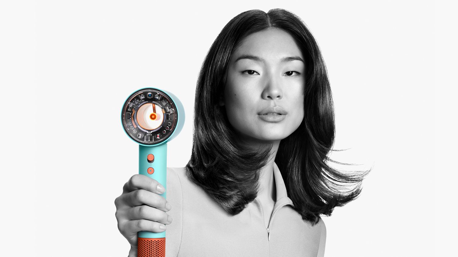 A female model using the Dyson Supersonic Nural hair dryer