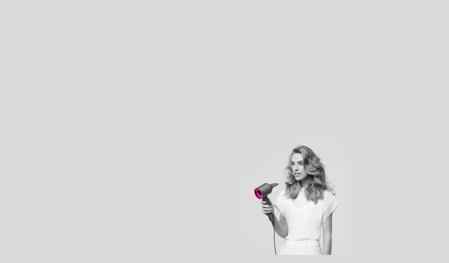 Woman using Dyson Supersonic with Styling concentrator attachment