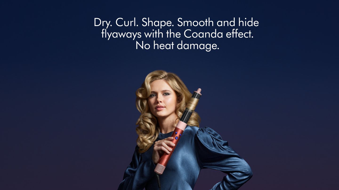 woman holding the Dyson Airwrap Strawberry Bronze