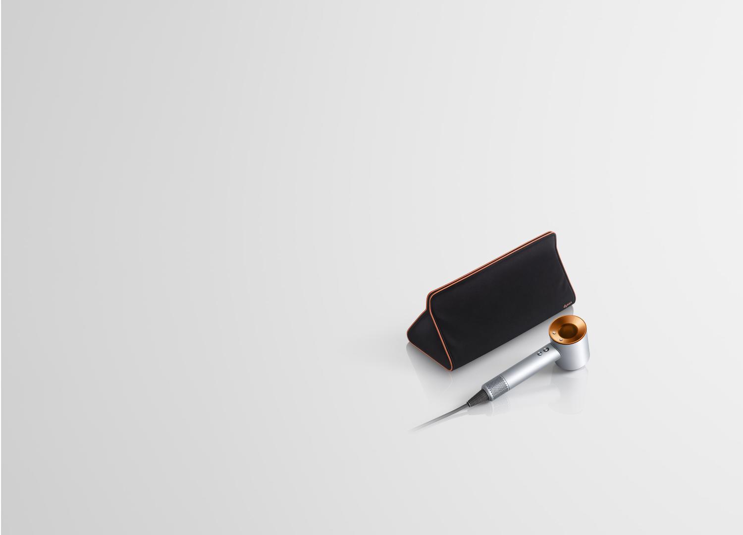 Copper Dyson Supersonic hair dryer with storage bag