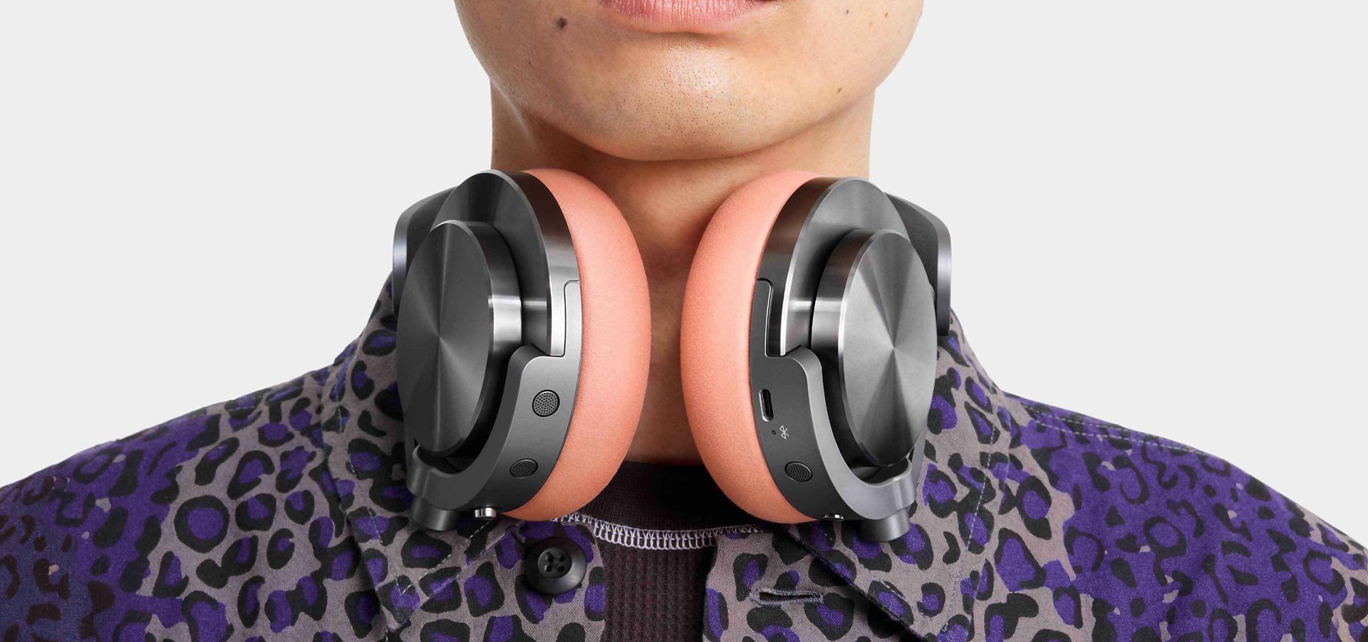 A model wearing the Dyson OnTrac headphones around their neck.