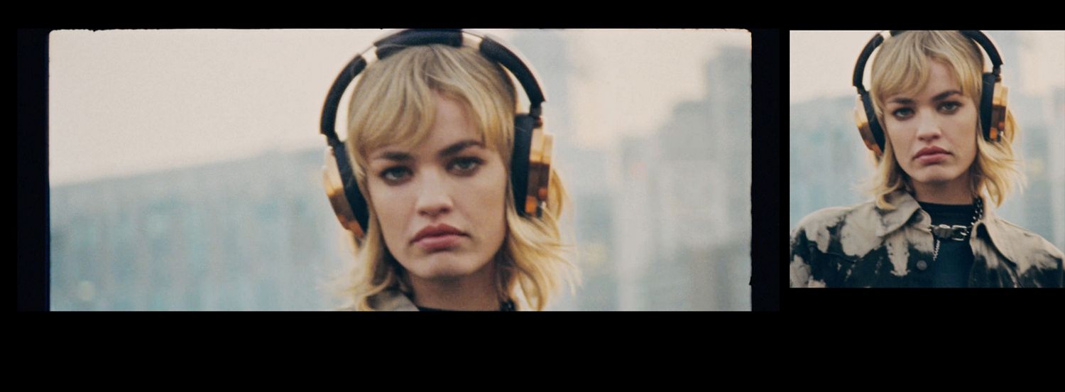 A female model wears a pair of Dyson OnTrac wireless headphones in an urban environment