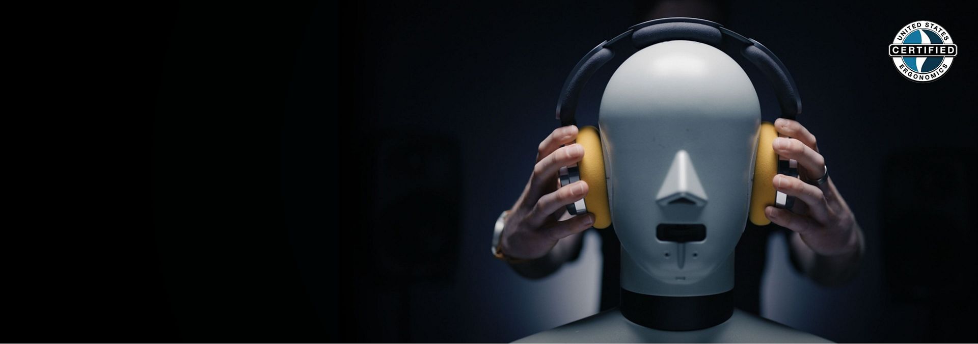Close-up of the headphones on a mannequin during tests. United States Ergonomics certified graphic.