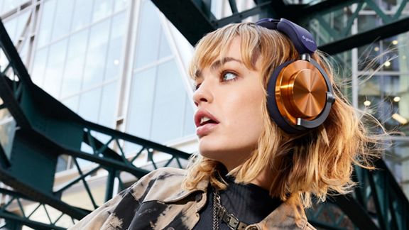 Model wearing the Dyson OnTrac headphones.