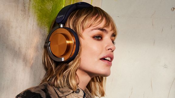 Model wearing the Dyson OnTrac headphones.
