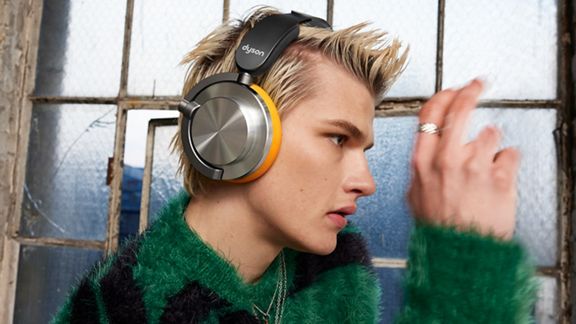 Model wearing the Dyson OnTrac headphones.
